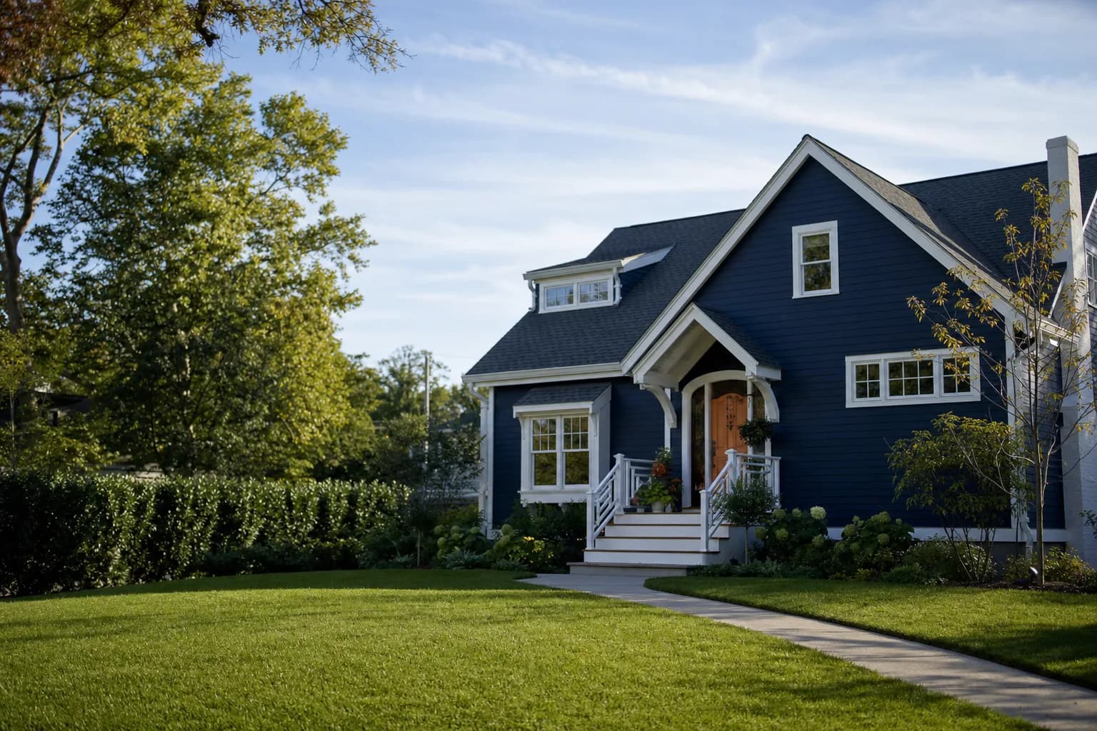 Charming home with a bold navy-blue exterior and white trim