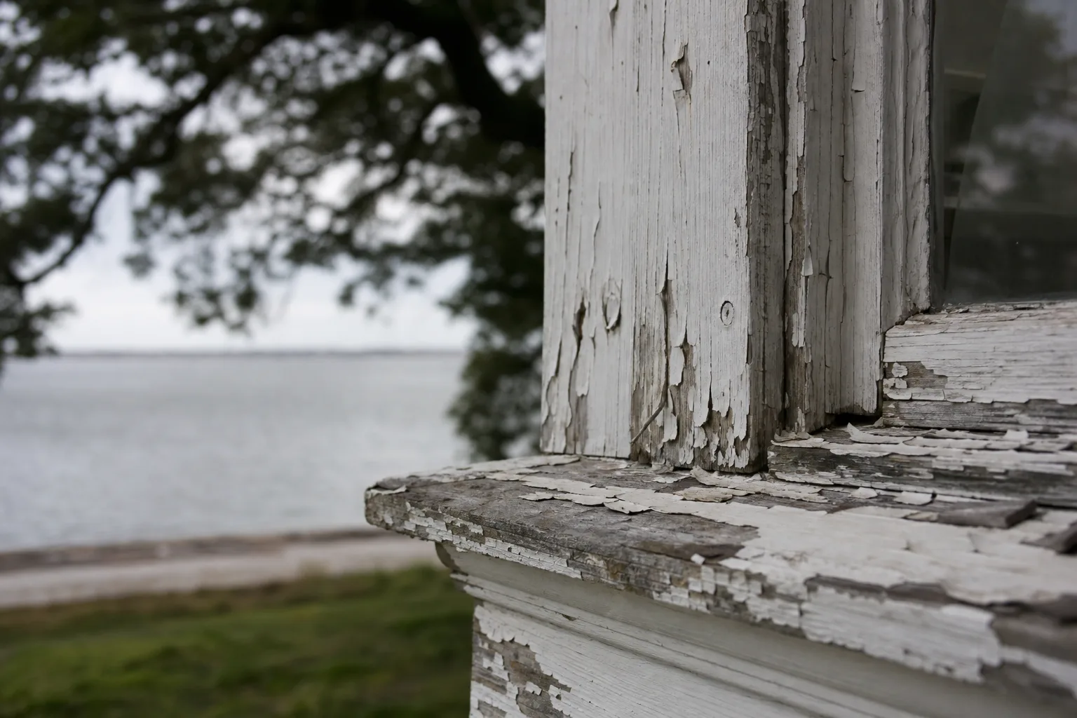 Close-up of salt air paint damage peeling and blistering on a coastal Gulf Coast home's trim