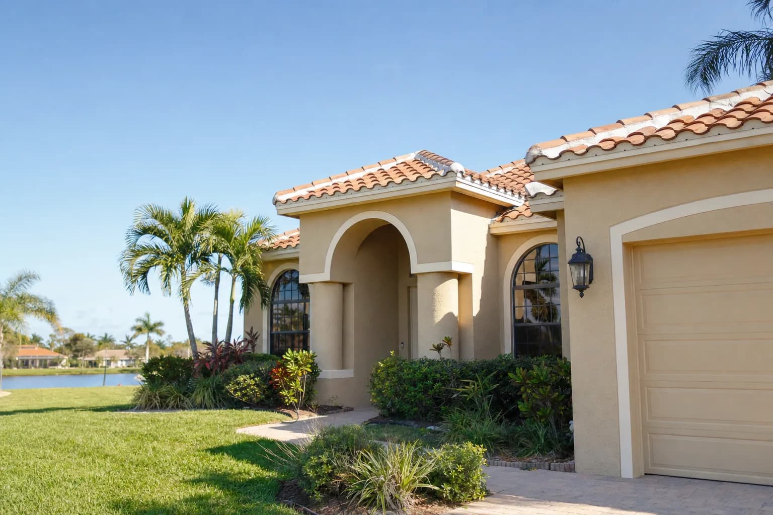 Tan stucco home exterior with visible texture, freshly painted