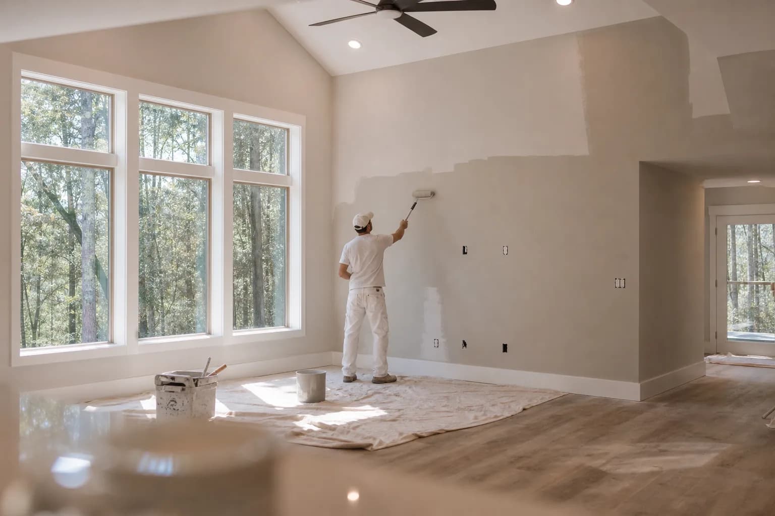 Painter refreshing the open great room of a newer Spanish Fort, AL home in a cohesive whole-home palette