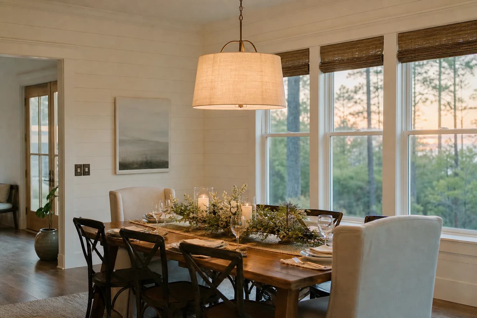 Freshly painted warm-neutral dining room set for holiday guests with crisp white trim