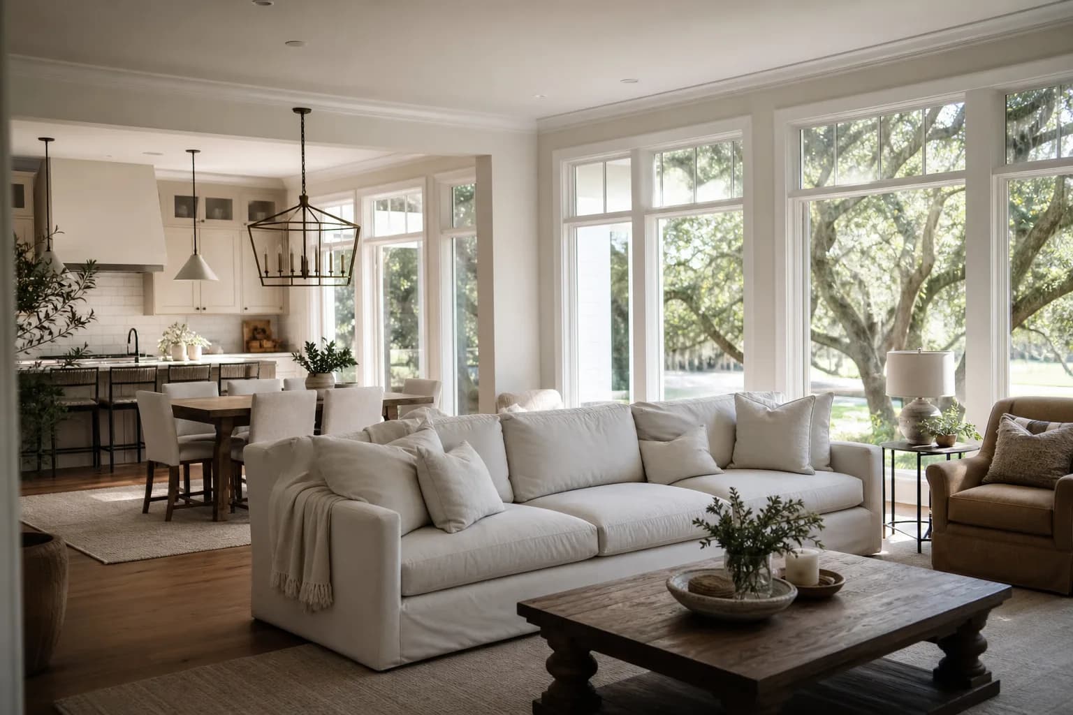 Open-concept living, dining, and kitchen painted in one connected whole-home color palette with consistent white trim